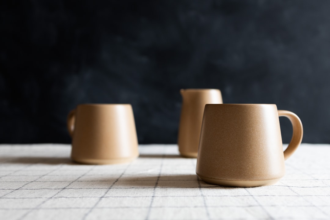 three-coffee-cups-sitting-on-top-of-a-table-i-a6nnj-0uo