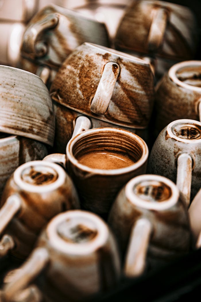Stack of handcrafted ceramic mugs with earthy tones at a market in Baku, Azerbaijan.