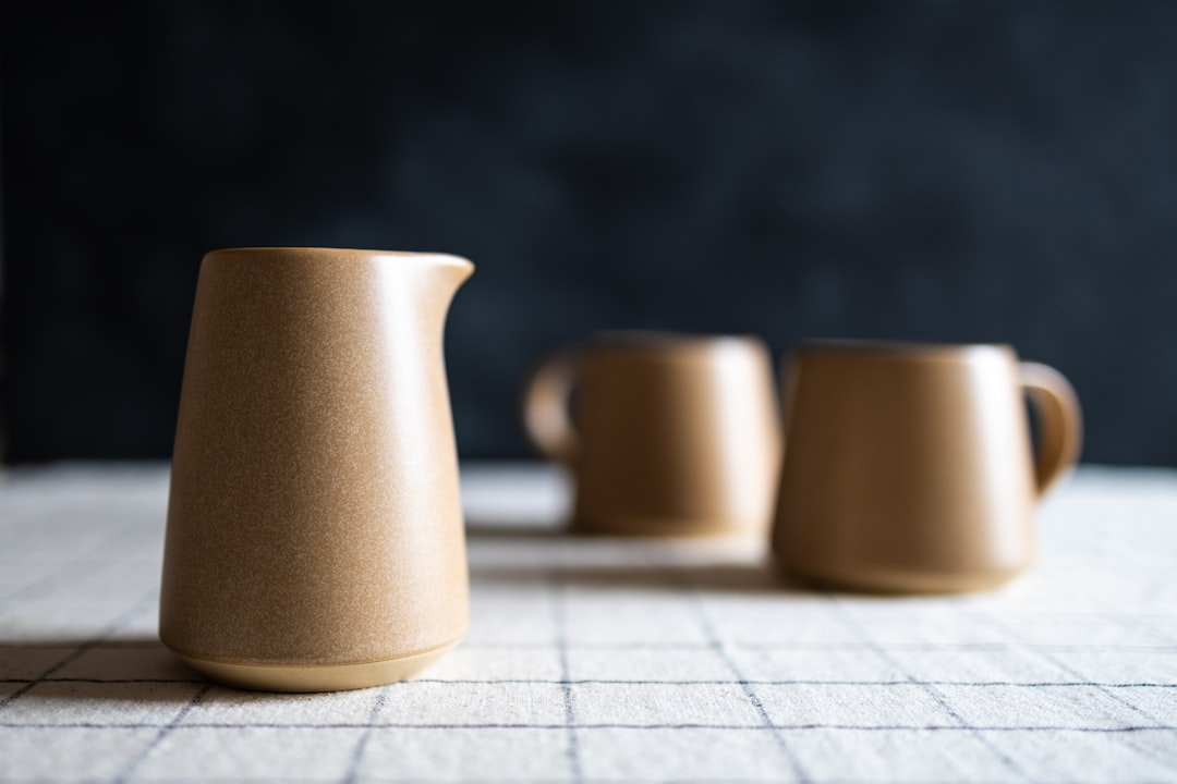 a-couple-of-cups-sitting-on-top-of-a-table-nuivaf6uami